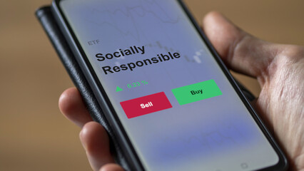 An investor's analyzing the socially responsible etf fund on a screen. A phone shows the prices of Socially sustainable to invest.