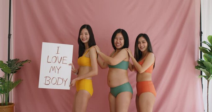 Diverse group of asia people lady show self love smile look at camera in studio model photo shooting. Happy proud pride of woman power holding placard plus size fat posing and slim skinny figure type.