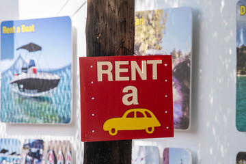 Rent a car wooden chalkboard sign or symbol in touristic place.