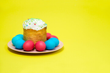 Easter cake and painted eggs on a yellow background, copy the place for the text