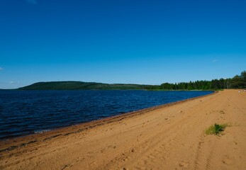 Calm lake view in the forest, blue sky