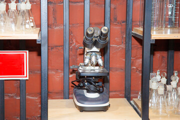 Electron microscope stands on the shelf of the scientific laboratory