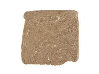 Top view of a piece of sunflower halva isolated on a white background.