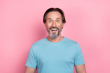 Photo of handsome cheerful mature man see huge sales promo on black friday isolated on pink color background