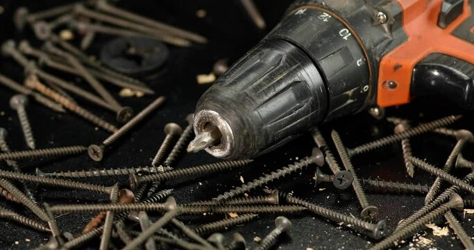 Man hands put drill and self-tapping screws, finished work, The choice of fasteners at the workshop or hardware store