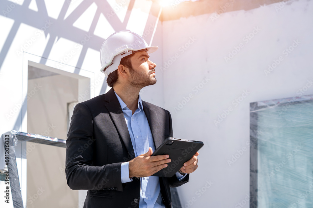Leinwandbilder manager using tablet checking the construction progress of the housing project.