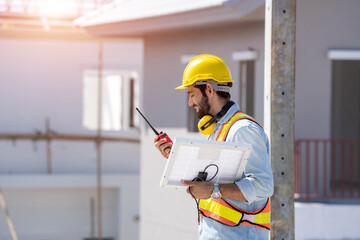 Engineer holding Walkie-Talkie are working at the construction of housing estates,Concept of...