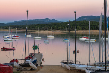 Sunset on Lake Montbel in Ariege with the boats in the summer of 2022.