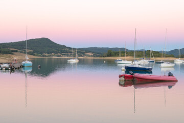 Sunset on Lake Montbel in Ariege with the boats in the summer of 2022.