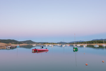 Sunset on Lake Montbel in Ariege with the boats in the summer of 2022.