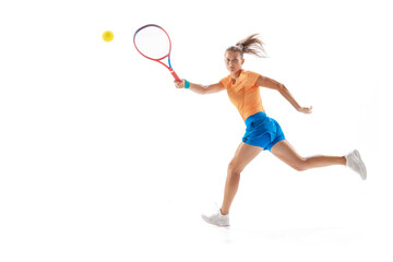 Portrait of young sportive woman, professional tennis player in motion, training isolated over white studio background