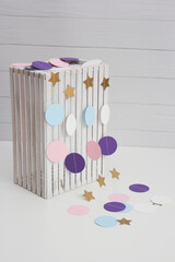 cardboard garland on the background of a white wooden box