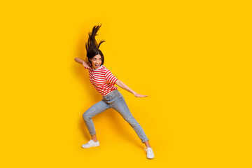 Fototapeta na wymiar Full body profile portrait of energetic active person fight empty space kung fu isolated on yellow color background