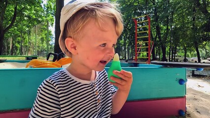 A small sick child uses a nasal aspirator into the nose, sucking out the mucus. Salty sea water helps to cure snot in a child. Copy space - concept of health, cold, immunity, prevention, cleansing