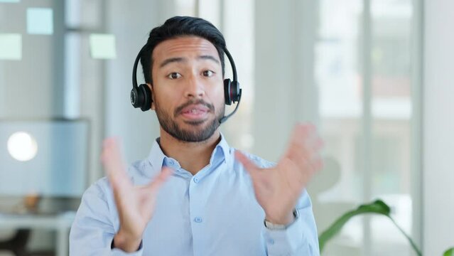 Businessman on a video conference call, virtual meeting or online consultation wearing headset in the office. Happy face of a call center support agent looking at the camera during a global webinar