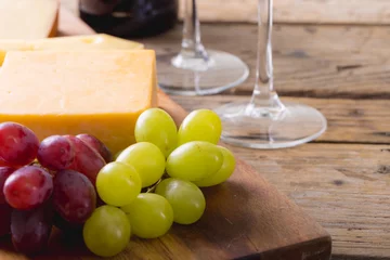 Foto op Canvas Close-up of cheese with grapes on wooden board, copy space © wavebreak3