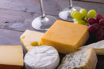  High angle view of various cheese with grapes on table, copy space © WavebreakMediaMicro