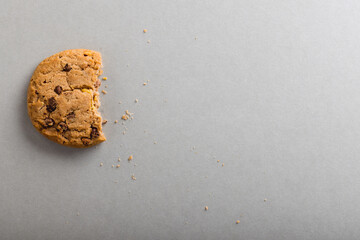 Directly above shot of half eaten cookie on gray background with copy space