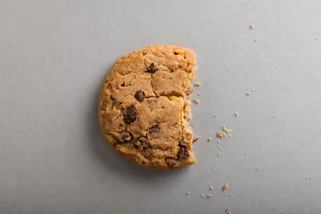 Foto op Canvas Directly above shot of half eaten cookie on gray background with copy space © WavebreakMediaMicro