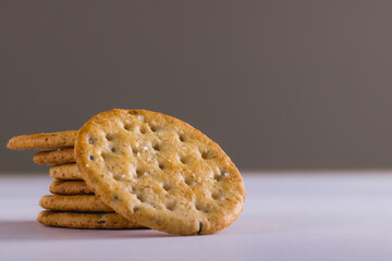 Close-up of stacked crackers against gray background with copy space - Powered by Adobe