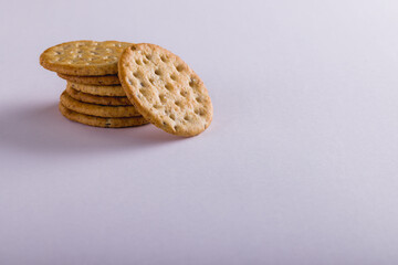 Close-up of stacked crackers against white background with copy space