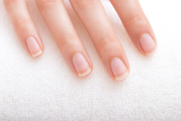 Beautiful natural fingernails and fingers of young woman after manicure