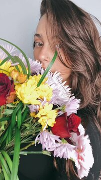 Woman Hiding Behind a bouquet of flowers, Flowers, Bunch of Flowers, Flower portrait, Portrait of a woman with Flowers, Attractive woman with Flower, Vertical Video, Social Media,