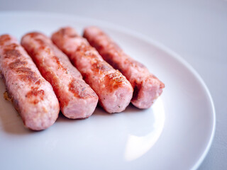 Tasty fried minced pork sausages on a grey big plate