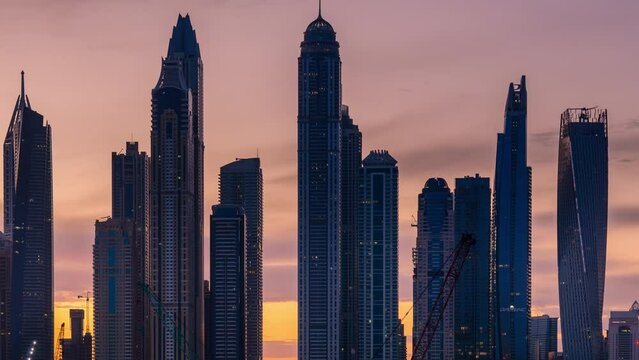 Dubai UAE-April 17,2019: Time lapse of  sky sunrise with high rise building  in Dubai Marina.