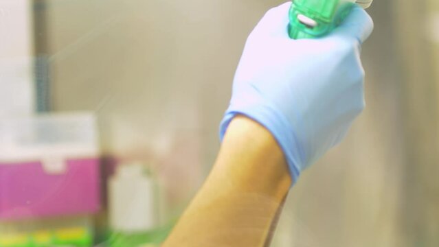 4k real time - hospital staff carrying out medical research in the laboratory with pipettes, test tubes, samples, etc...