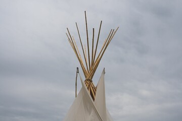 View of the upper part of the Native Teepee on the sky background © Theresa M/Wirestock Creators