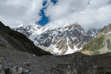 Beautiful alpian mountains landscape in the clouds. Amazing close-up view on the glacier.