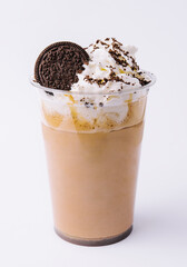 Chocolate milkshake covered with whipped cream in plastic glass isolated