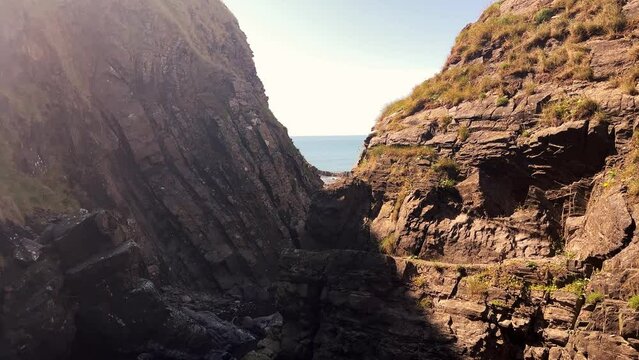 Speke's Waterfall falling to the ocean through the Hartland Quay Cliffs