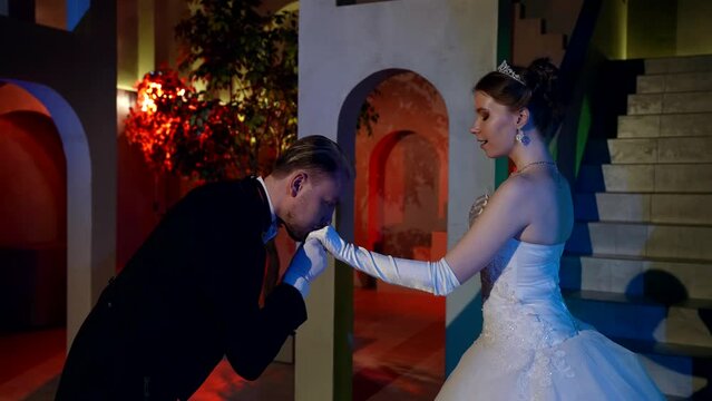 romantic date of beautiful young princess and elegant man in palace in night in ball