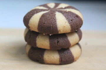 pile of striped cookies on a wooden board