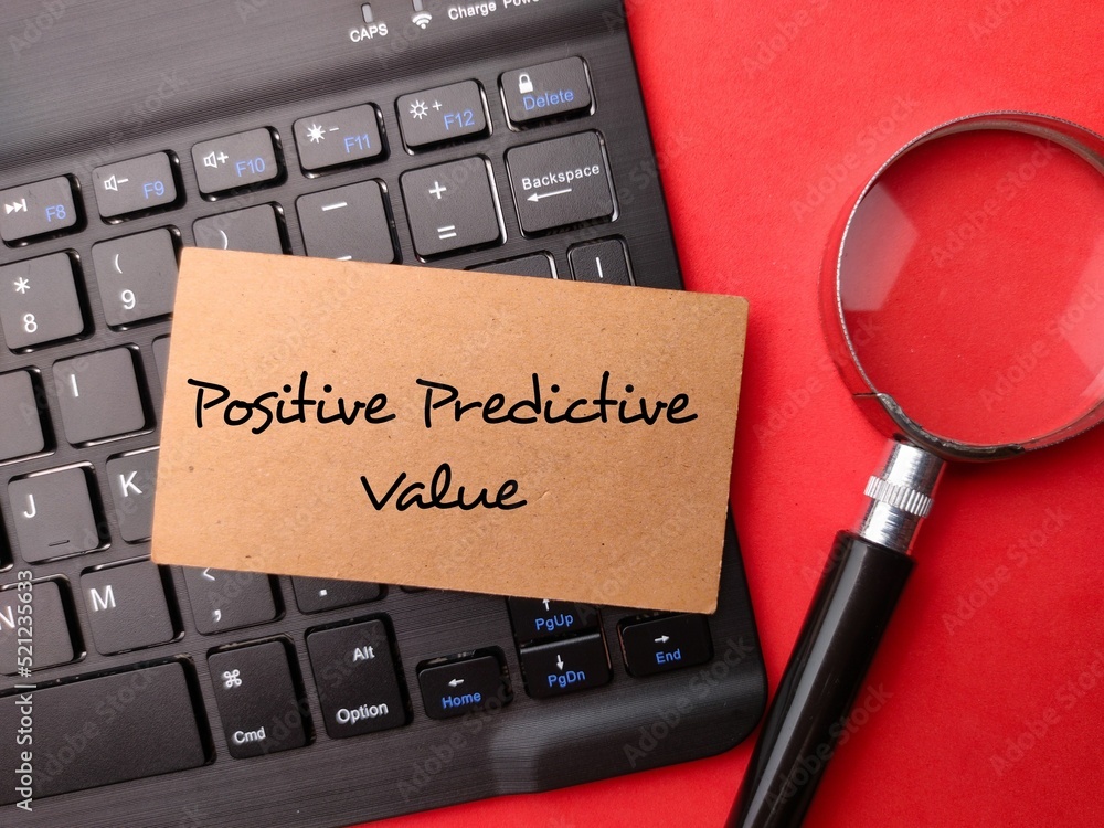 Poster magnifying glass and wireless keyboard with the word positive predictive value on red background