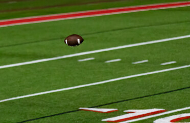 Football pass throw in the air over football field - American football