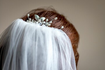 Closeup of a silver hairpin on the bridal veil