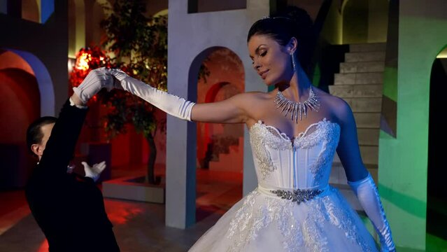 beautiful princess and handsome prince are dancing in ballroom, romantic atmosphere in royal palace