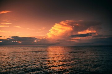 Beautiful scenery of a sea surface during sunset with the last sun rays covering the