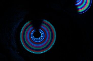 Time-lapse photograph of an uncompleted circle with multicolor light. - obrazy, fototapety, plakaty