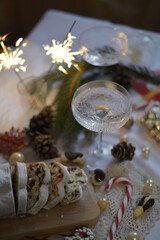 a glass of champagne at christmas with a galley surrounded by sparklers and decoration
