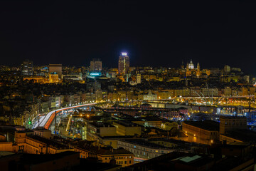 Panoramic view of Genoa at night with the causeway and the buidings of the historic center, Italy