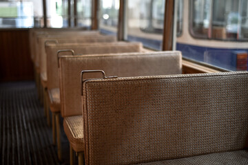 Fototapeta na wymiar Interior detail with elegant seats of a vintage tramway