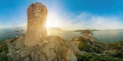Ancient Genoese Parata tower by the Mediterranean sea in Corsica island of France. Aerial sunset...