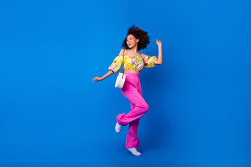 Full length photo of overjoyed pretty girl have fun dancing clubbing isolated on blue color background