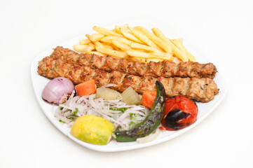 Chicken Kabab with fries, salad, tomato, onion served in a dish isolated on grey background side view of fastfood