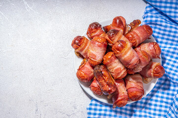 Oktoberfest party food. Pretzel hot dogs, puff pastry rolls with sausage and bacon, traditional Bavarian German  Pigs in blanket on Oktoberfest decorated table background