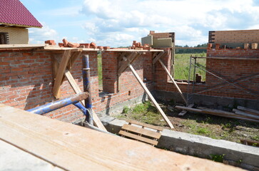  Construction of a brick and wooden roof house construction in progress